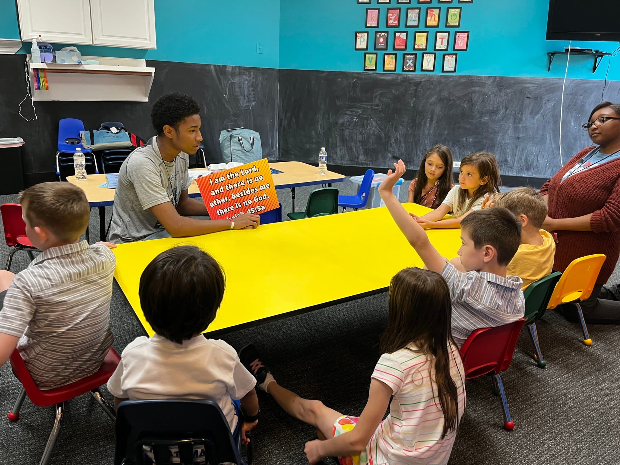 Good News Club session with children around a classroom table